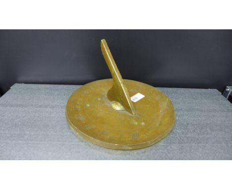 A decorative wooden faux brass sundial of traditional design 25cm wide 