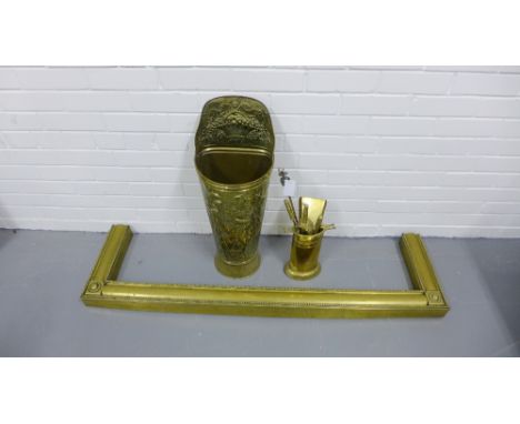 Brass embossed stick stand together with a brass fireside companion set and a brass fender (a lot) 