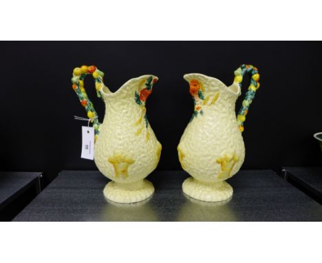 A pair of Clarice Cliff Celtic Harvest jugs with fruit moulded single loop handles, 27cm high (2)