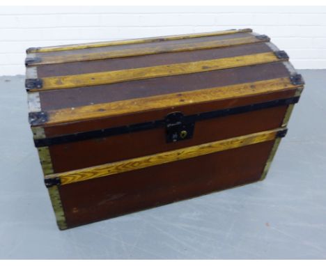 A domed topped canvas bound travel trunk, 84 x 54cm