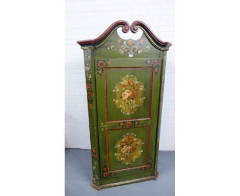 A 19th century Continental painted pine wardrobe having a broken swan neck pediment to top over panel door enclosing a fitted
