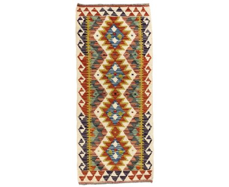 Chobi Kilim runner, multi-coloured ground with overall geometric design, decorated with four stepped lozenge medallionsDimens