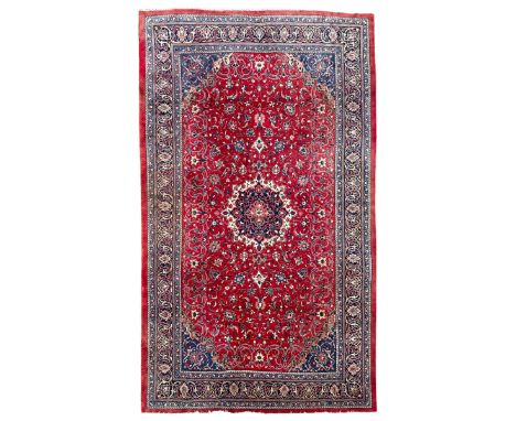 Persian Mahal crimson ground carpet, the field decorated with a central floral pole medallion, surrounded by scrolling foliat