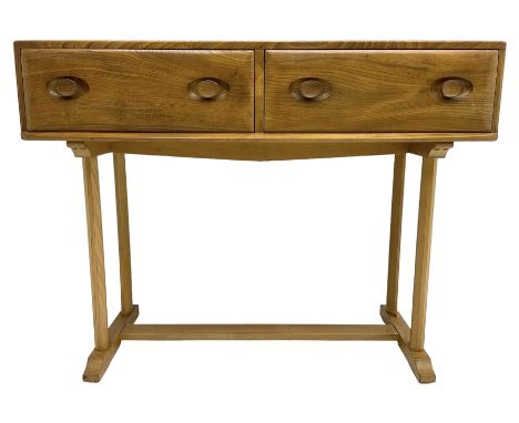 Ercol - circa. 1960s elm and beech side or console table, fitted with two drawers, pillar supports on sledge feet joined by s