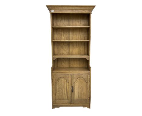 Light oak open bookcase cupboard, projecting cornice over three shelves, fitted with double cupboard enclosed by arched panel