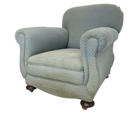 20th century traditional shape armchair, curved back and rolled arms, upholstered in light blue patterned fabric, on turned f