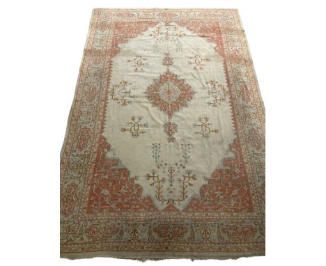Large Persian pale sage ground carpet, the field decorated with central geometric medallion and tree of life motifs, the bord