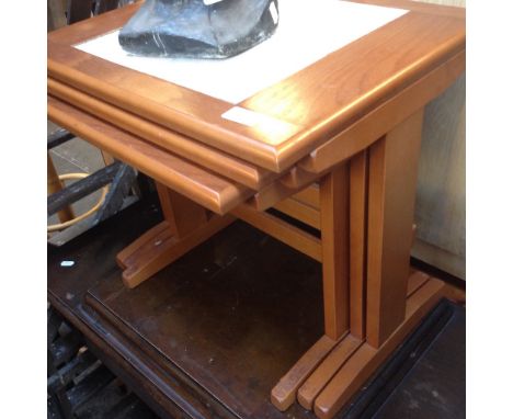 A TILE TOP NEST OF TABLES