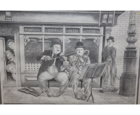 A FRAMED AND GLAZED LAUREL AND HARDY PRINT PICTURE SIZE - 43CM X 33CM 