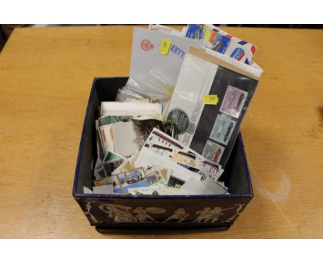 A TIN OF ASSORTED STAMPS AND FIRST DAY COVERS