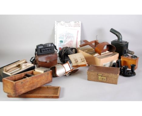 A large number of stereoscopic slides, two early 1900s slide viewers, a tin plate projector, a later electric slide projector