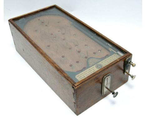 BYGONE PENNY OPERATED BAGATELLE GAME, 'The Advance Pin Table' in glazed oak case, 23" x 11 3/4" (58.4cm x 29.9cm) 