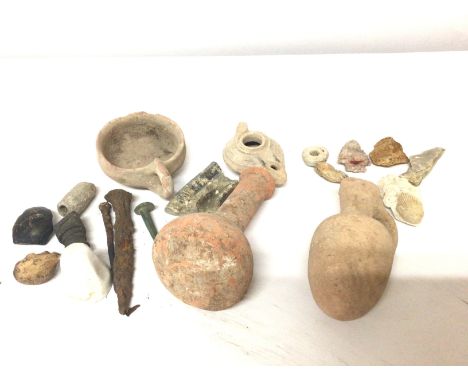 A collection of Roman Antiquitys clay pots and an oil light other archaeological finds including arrow head flints nails etc.