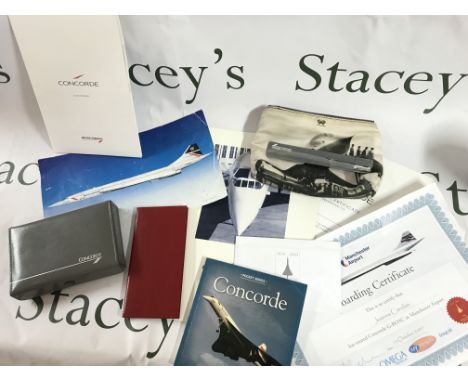 A box containing Concorde memorabilia including playing cards, note pad, pocket book, boarding certificate etc. postage categ