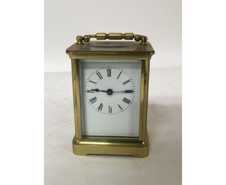A brass cased carriage clock enamel dial seen working. Height 11cm