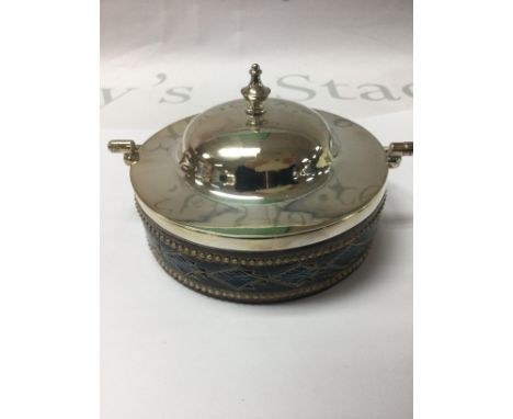 A Doulton Lambeth preserve jar with silver plated cover .