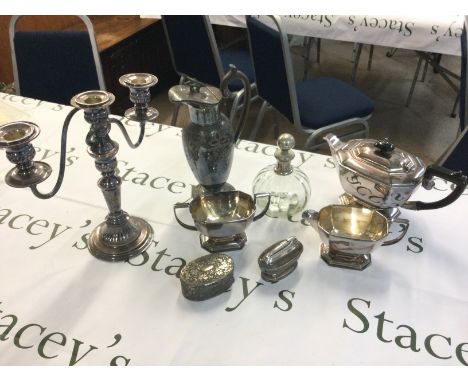 Silver plated items including a candelabra, sauce boat, table lighter, claret jug etc . Postage category B NO RESERVE