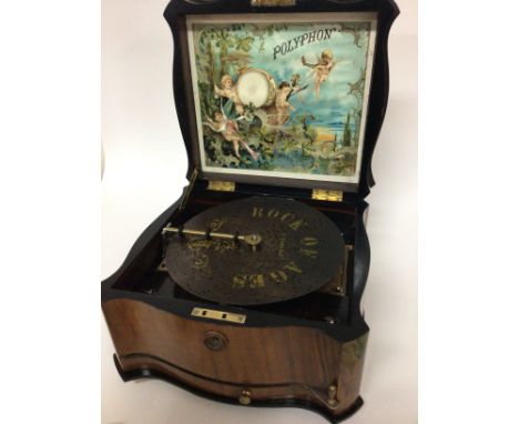 A late 19th century Continental walnut cased Polyphon in very good condition the shaped case with a hinged lid enclosing a co