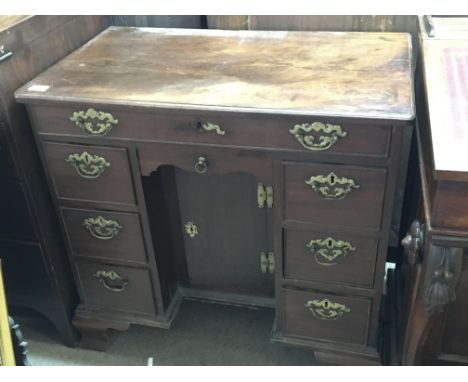 A George III 18th century red walnut Knee hole writing desk The rectangular top above flights of drawers and one long drawer 