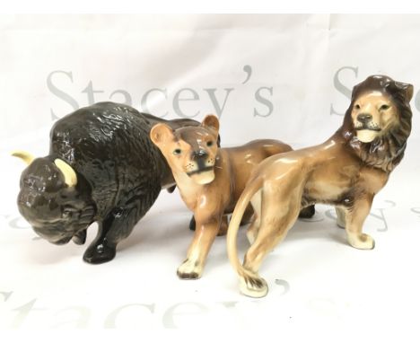Three ceramic animals including West German Made lions and a Melba Ware buffalo . This lot cannot be posted