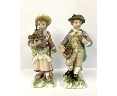 A pair of Sitzendorf porcelain figures of a boy and girl flower seller. 14.5cm. NO RESERVE