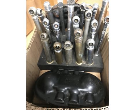 Two small wooden stands holding 20 vintage tyre pressure gauges and 2 car bulb holders