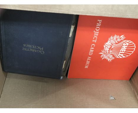 A box containing a large quantity of cigarette and tea card albums.