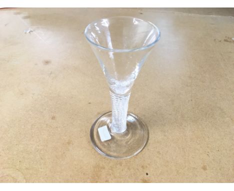 An 18th century drinking glass circa 1750 a drawn trumpet bowl above an air twist stem rasied to a circular spread foot. 13cm