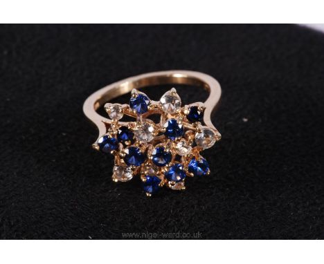 A 9ct Gold ring set with a profusion of Sapphires and white stones.