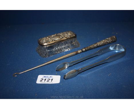 A pair of Silver sugar tongs, Silver handled button hook and a Silver topped pin box