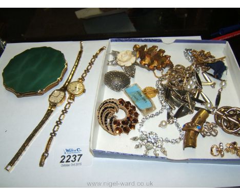 A quantity of costume jewellery including brooches, necklaces, Acurist wristwatch, compact, etc.