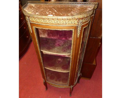 A late 19th century French mahogany, gilt metal mounted and rouge marble inset single door glazed vitrine, of shaped form, wi