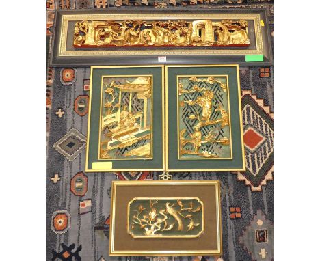 A Chinese relief carved and gilt decorated rectangular wall panel, depicting scholars within a landscaped exterior, together 