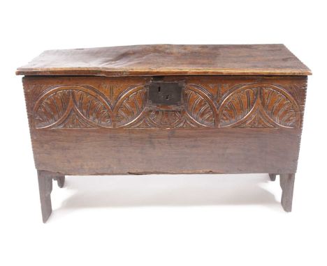 A mid-17th century joined oak plank coffer, the hinged cover on original steel loop hinges, the interior once fitted with can