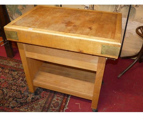 A beech and brass bound butcher's block on stand, the two-tier stand with single upper drawer and on roller castors, width 93