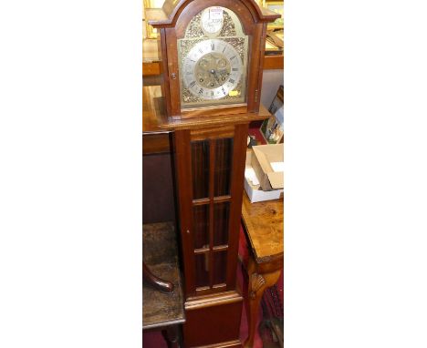 A mahogany Tempus Fugit grandmother clock, having an arched silvered and brass dial, glazed trunk door, with pendulum, height