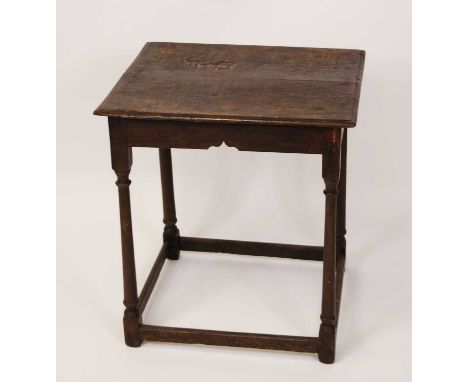 An 18th century provincial joined oak side table, having a two-plank top, raised on turned and square cut supports united by 