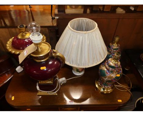 Two similar red glazed and gilt decorated ceramic table lamps, in the classical taste, together with a pair of Chinese style 