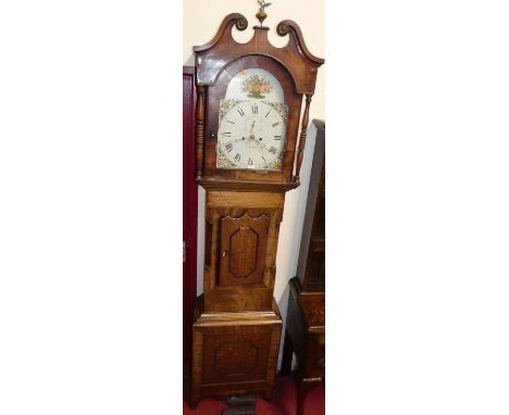 An early 19th century north country oak and mahogany long case clock, the arch painted dial signed York, with subsidiary seco