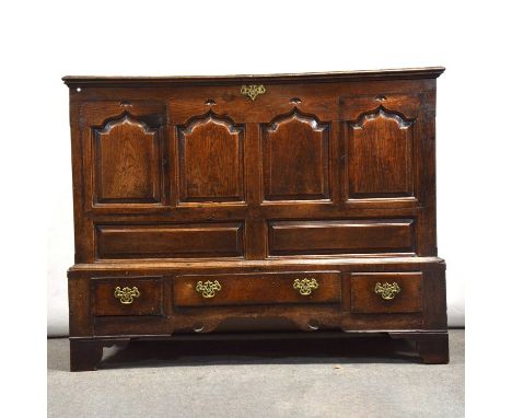 Joined oak mule chest, hinged lid above four arched fielded panels, the base with three drawers, bracket feet, width 145cm, d