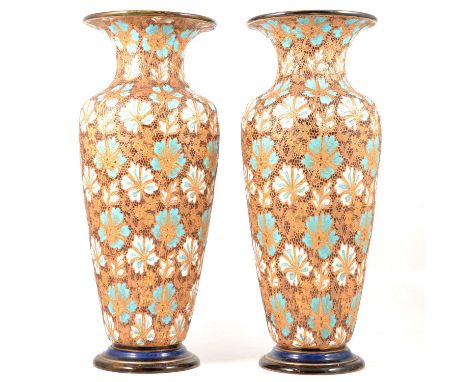 Pair of large Doulton Lambeth stoneware vases, stylised flowerhead design enamelled in white and turquoise with gilt outlines