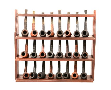 A three shelf pipe club rack with twenty-four St Claude wooden pipes, 40.5x45.5cm.Qty: 25