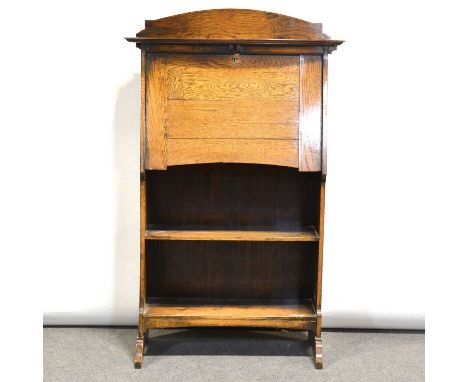 1940's oak slimline bookcase, bowfront top shelf above a fall front, open shelves below, width 75cm, height 124cm.