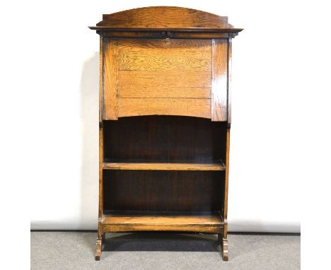 1940's oak slimline bookcase, bowfront top shelf above a fall front, open shelves below, width 75cm, height 124cm.