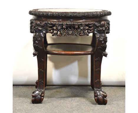 Large Chinese carved hardwood stand, marble inset top, the legs joined by a shelf, diameter 55cm, height 58cm.Condition repor