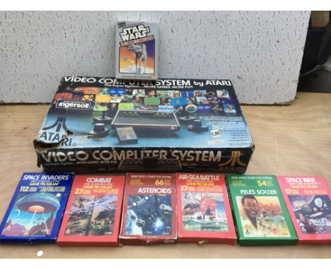 A boxed Atari video computer game console with seven boxed games, including Star Wars, Space invaders, Asteroids etc