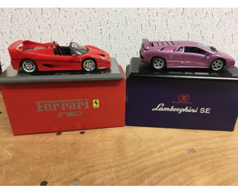 Ferrari F50 and a Lamborghini SE diecast 1:18 scale vehicles, boxed on plinths