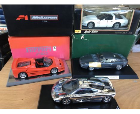 Collection of boxed diecast vehicles including 1:18 scale F1McLaren, Corvette ZR-1, Ferrari F50 and an Aston Martin DB7