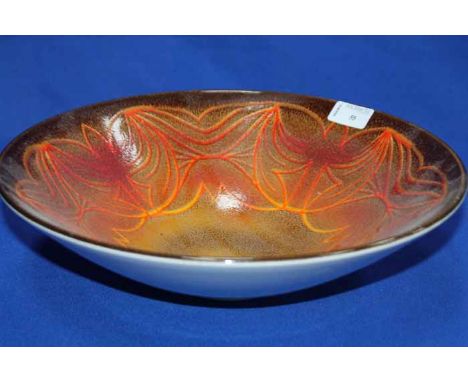 LARGE POOLE POTTERY BOWL
with orange and red pattern, marks to the base, 34cm diameter