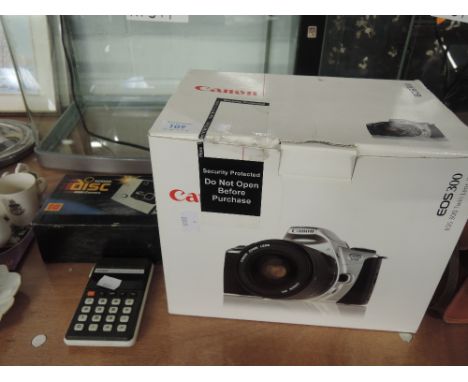 A Canon digital camera model EOS 300 with EF 75 - 300 lens and similar